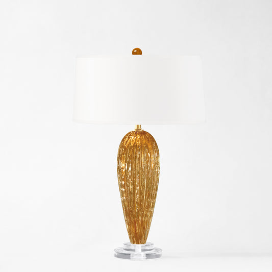 Amber Murano glass table lamp with white shade.
