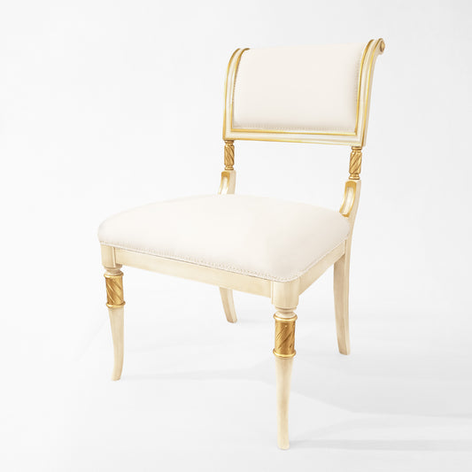 Antique white Italian chair with carved gold details and white fabric.