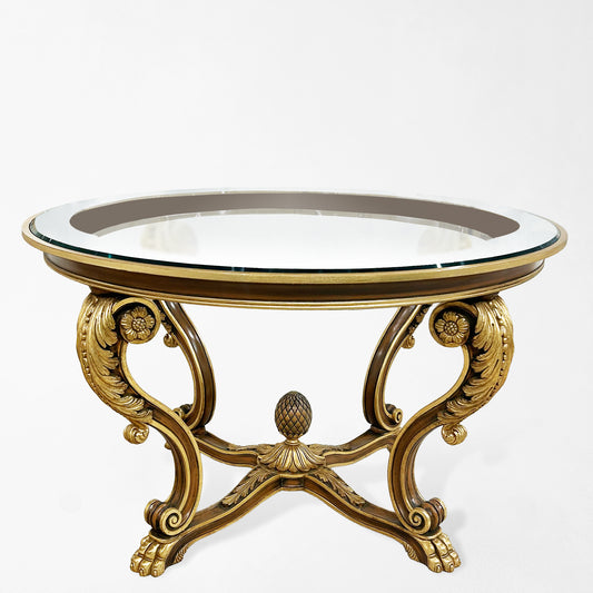Large brown and gold center table with glass top.