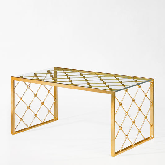 Gold coffee table with glass top.