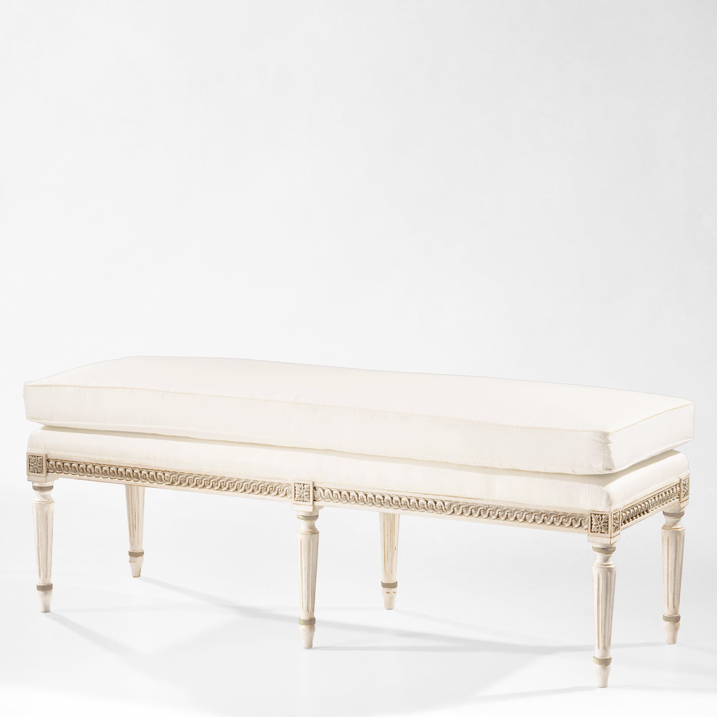 White Italian bench with silver details and cream cushion.
