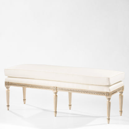 Antique white Italian bench with carved silver details and white fabric.