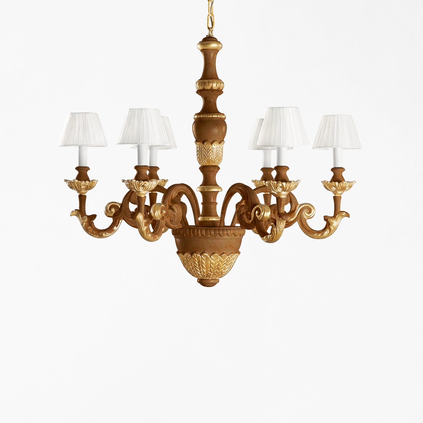 Traditional brown and gold Italian chandelier and white pleated shades.