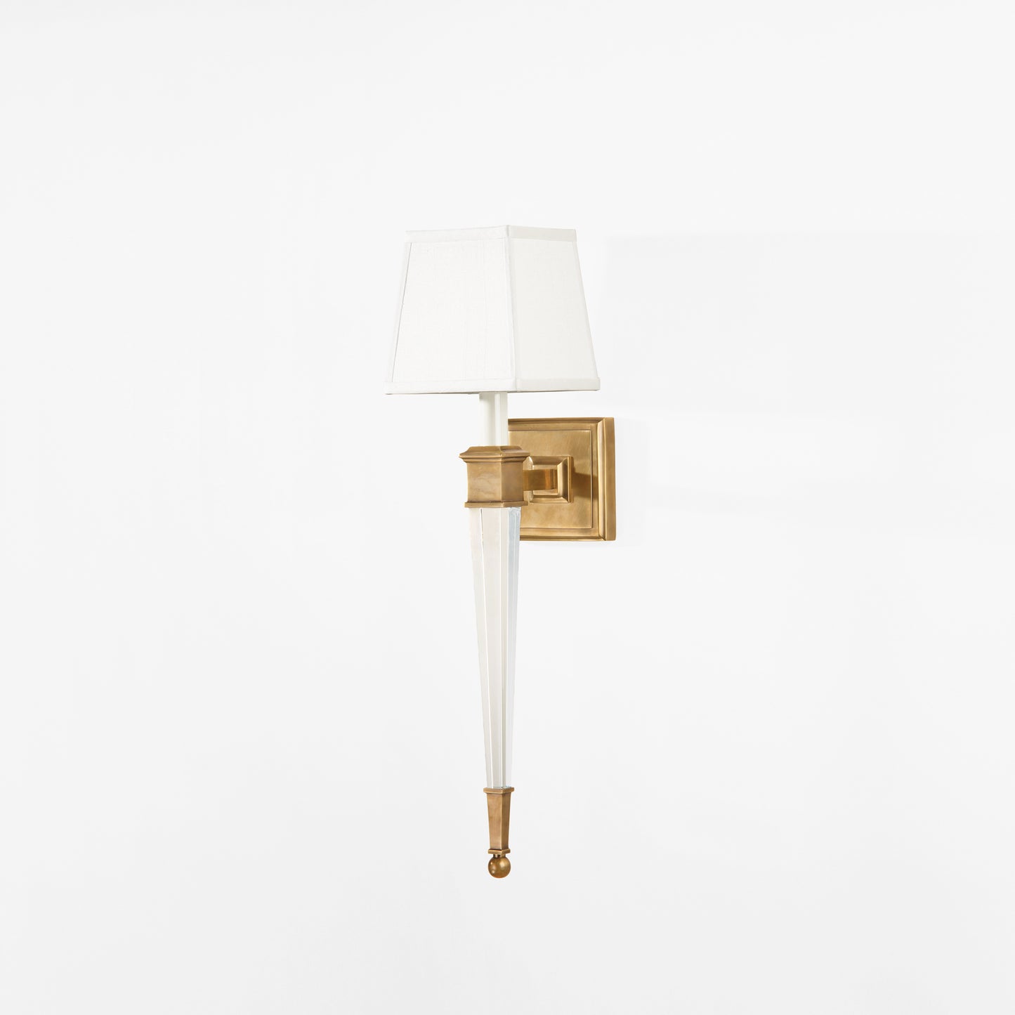 Luxurious crystal and brass sconce with white shade.