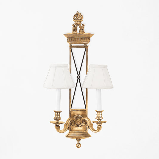 Luxurious brass sconce with white shades.