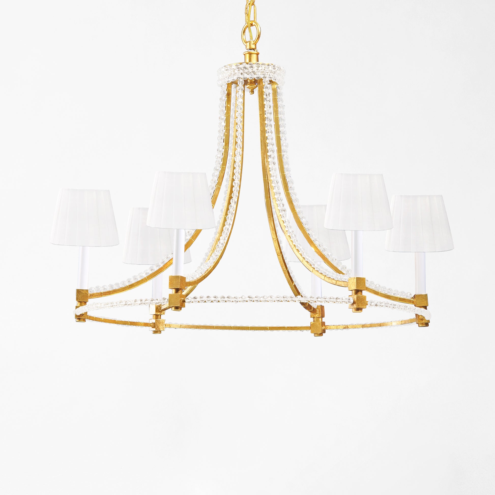 Gold Italian chandelier with crystals and white plated shades.