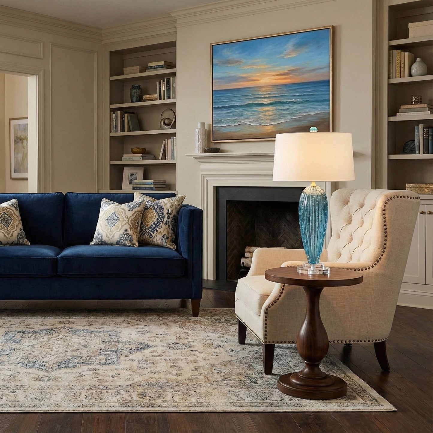 Living room with blue sofa, beige armchair, and a blue Murano glass lamp.