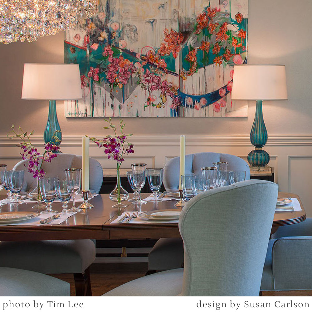 Blue Murano glass lamps in a luxurious dining room.