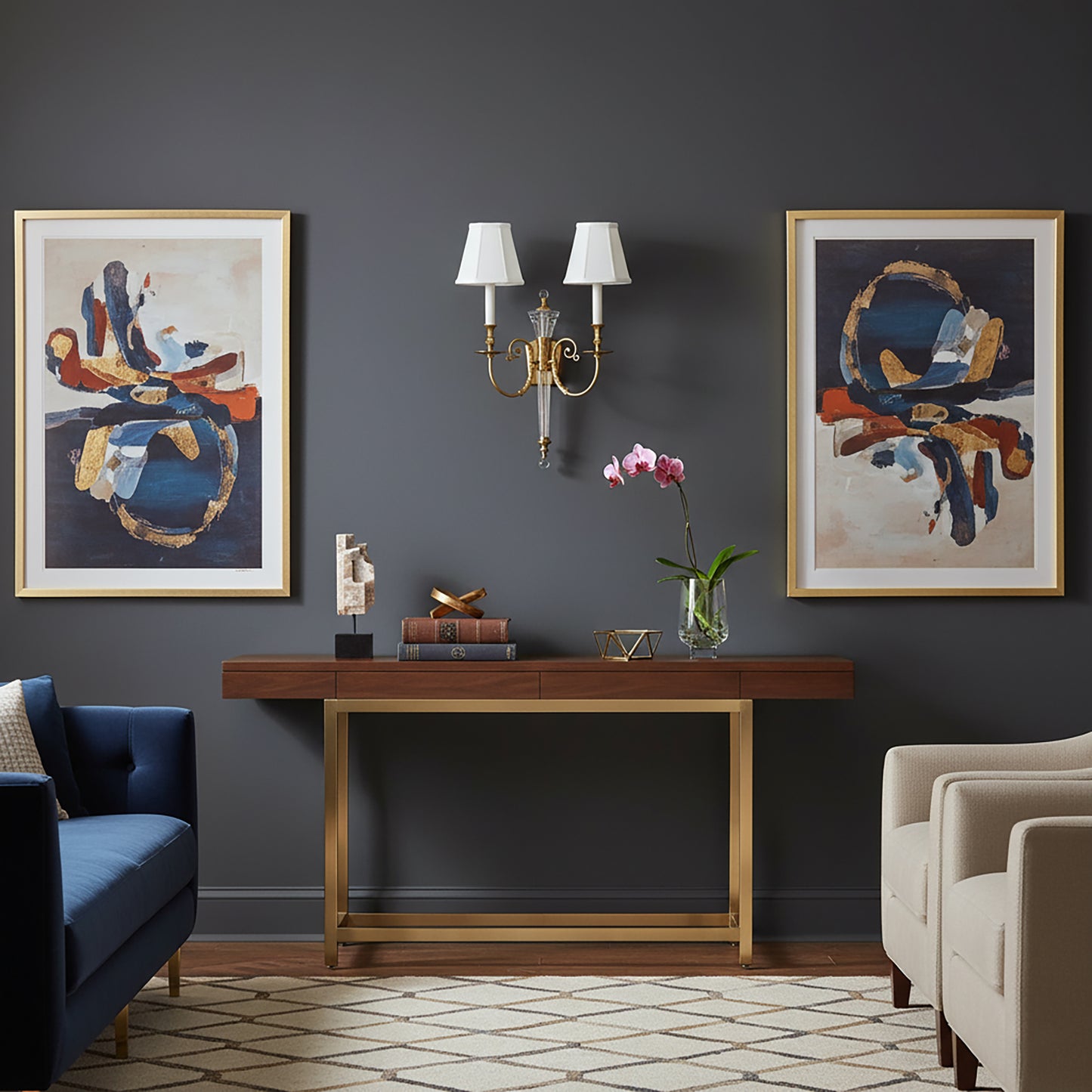 Living room with dark gray walls, a brass console table,  and a brass sconce.