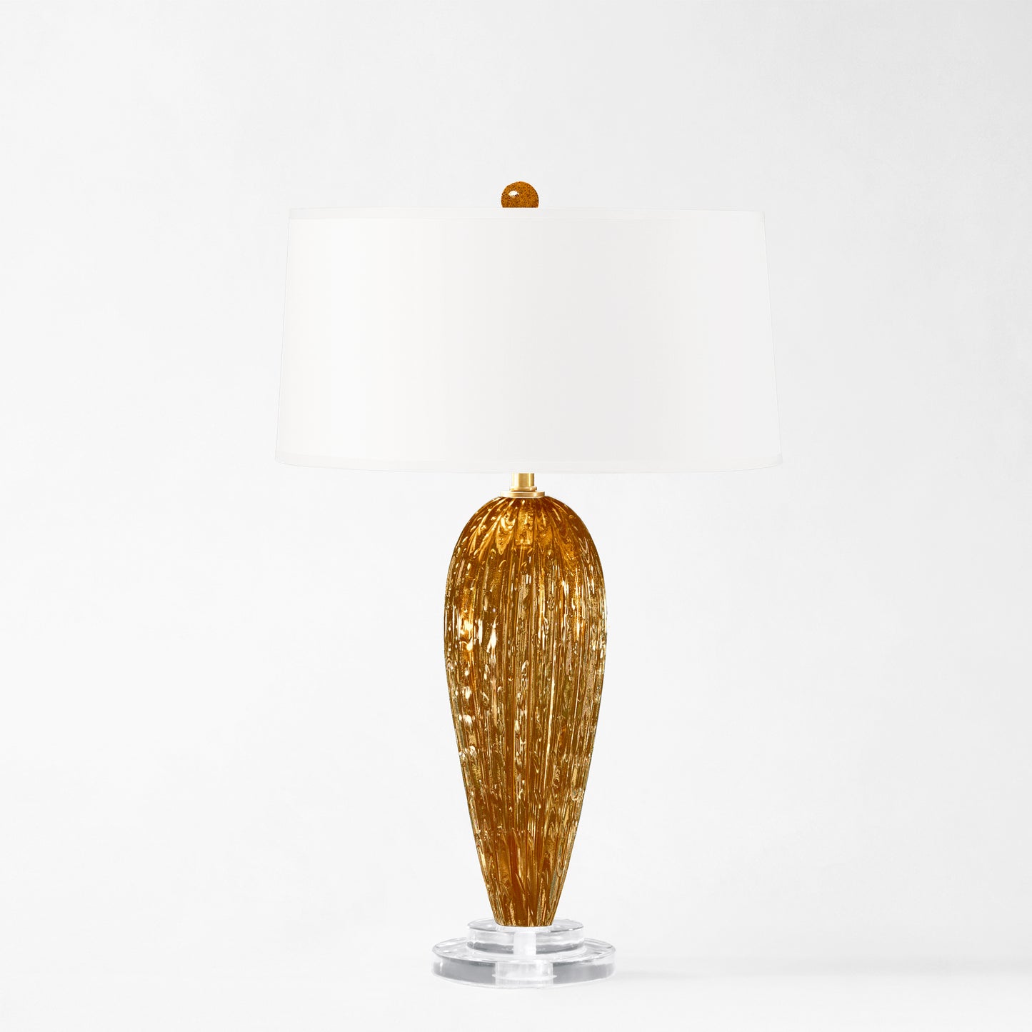 Amber Murano glass table lamp with white shade.