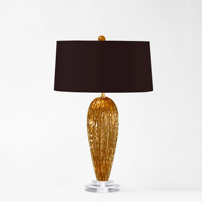 Amber Murano glass table lamp with black lamp shade.