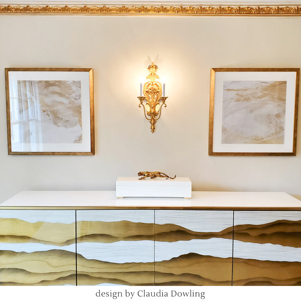 A gold sconce in a living room.