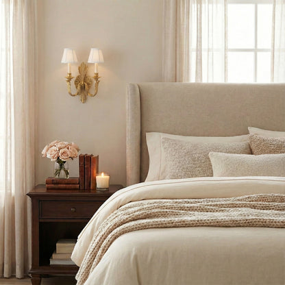 An antique brass sconce in a bedroom setting.