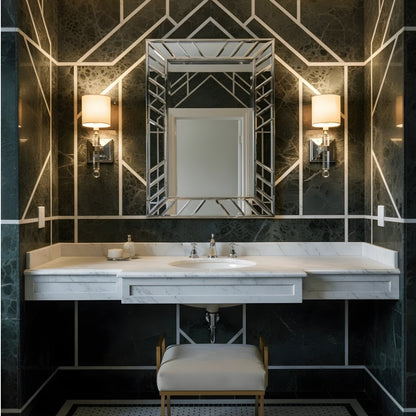 Bathroom vanity with geometric wall design and crystal sconces.