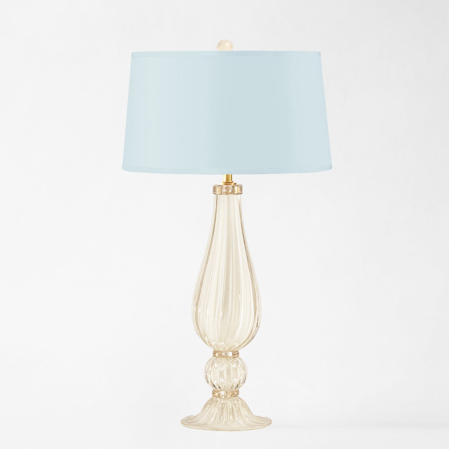 White Murano glass table lamp with light blue lamp shade.