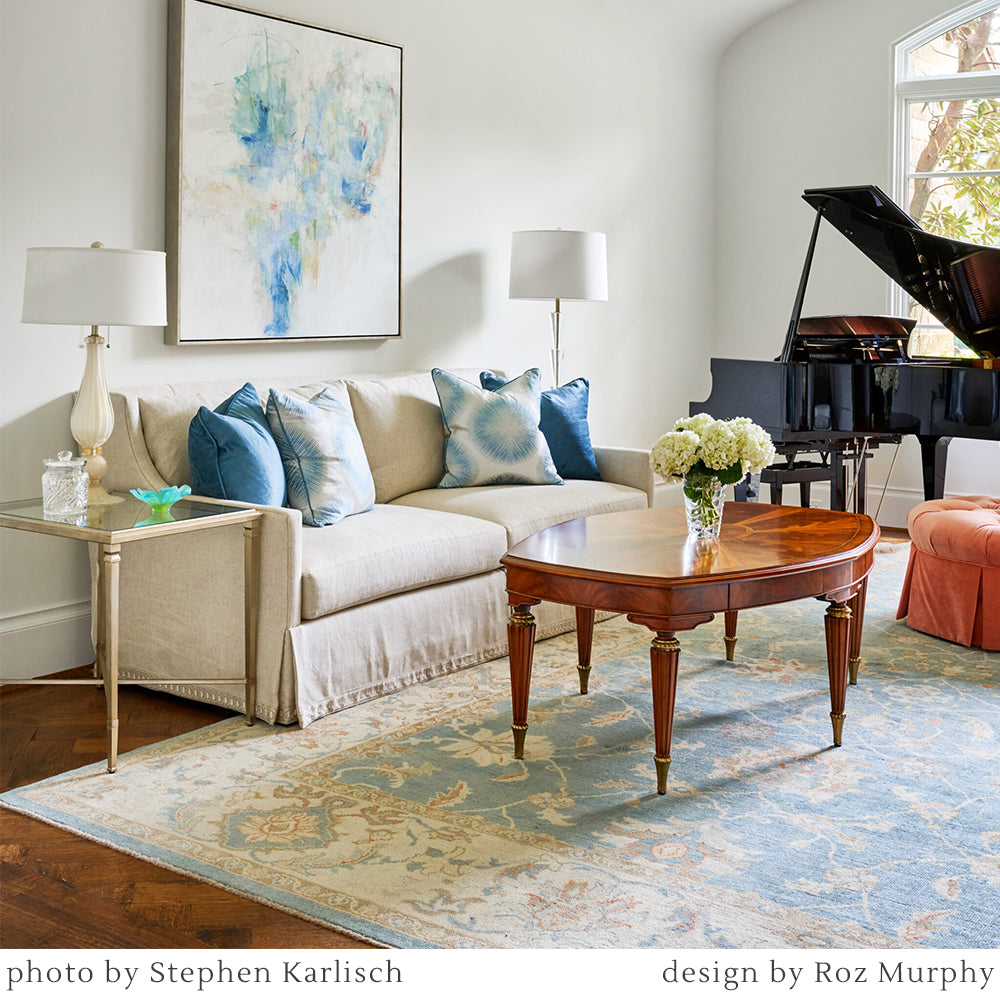 White Murano glass lamp in luxurious living room with traditional rug and Italian table.