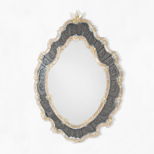 Black and gold ornate Venetian glass mirror.