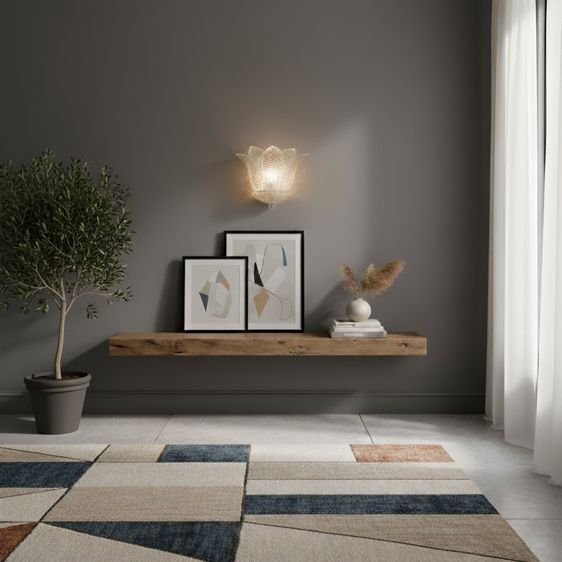 Handmade glass sconce on a grey wall in a transitionally designed room.