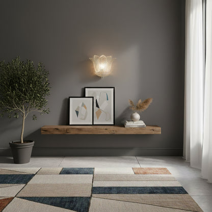 Handmade glass sconce on a grey wall in a transitionally designed room.