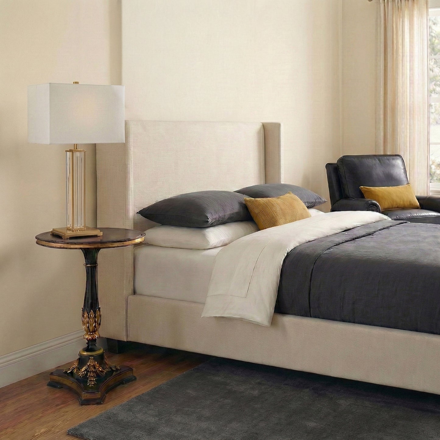 A bedroom with a handmade gold-leaf end table.