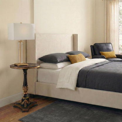 A bedroom with a handmade gold-leaf end table.