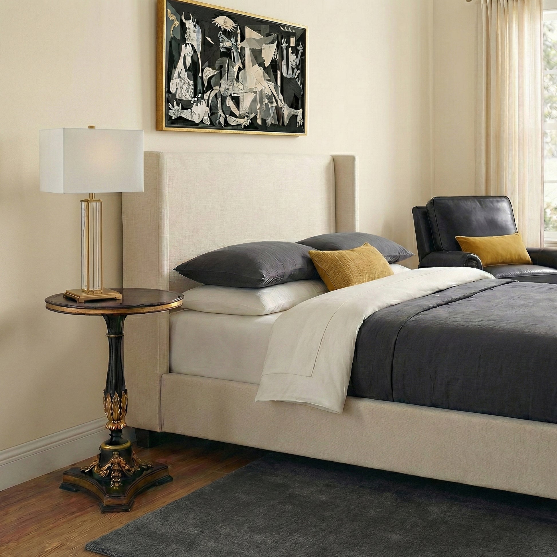 A bedroom with a handcarved gold-leaf end table.