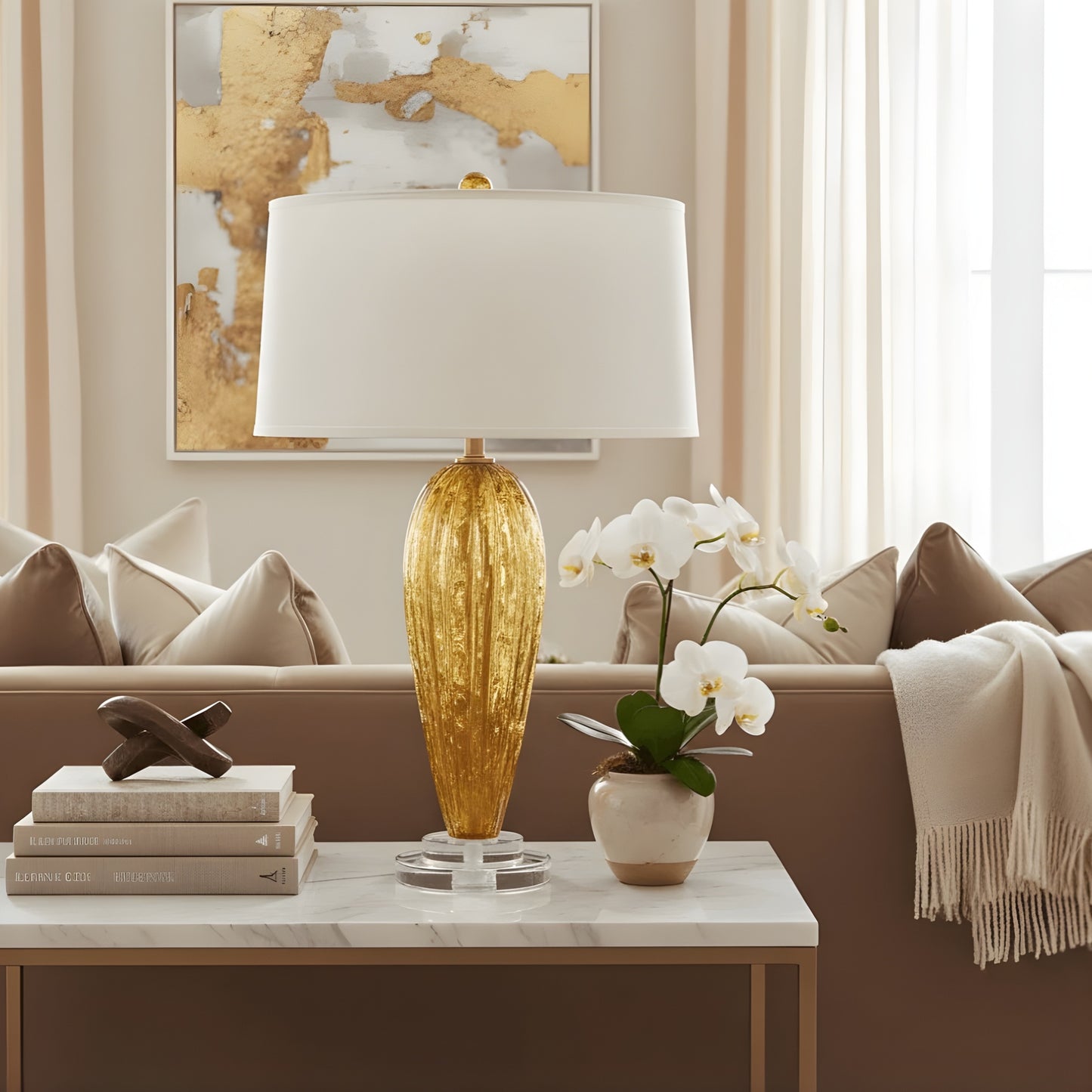 Decorative table with a Murano glass table lamp, books, and a plant in a living room setting.