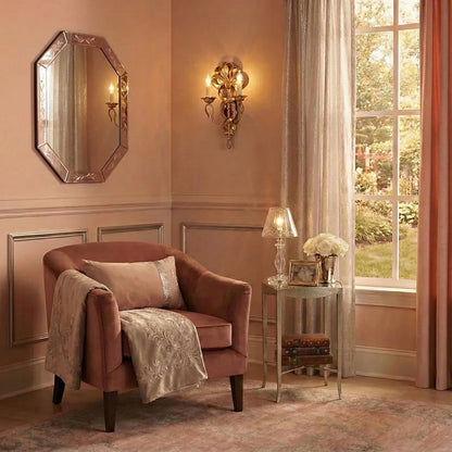 Luxurious living room with a plush armchair, decorative Murano glass mirror, and an antique silver wall sconce.