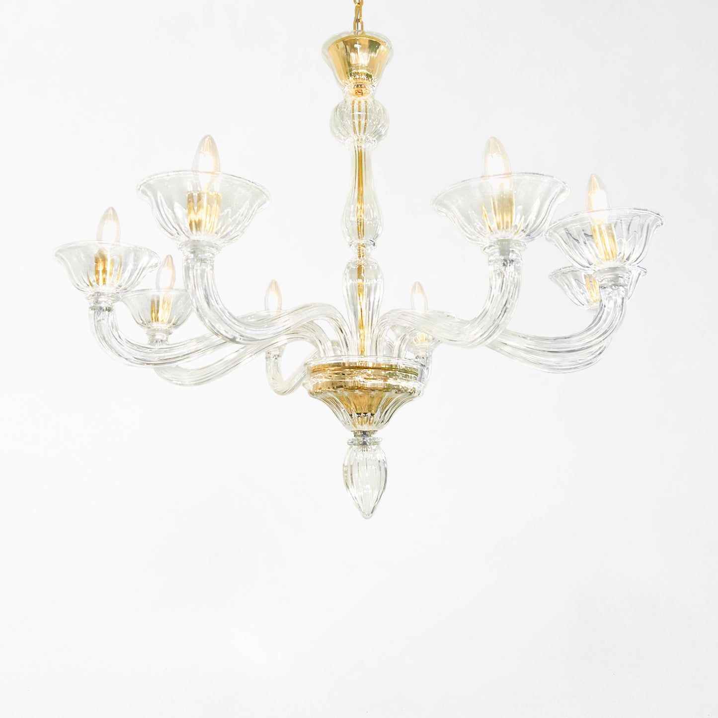 Clear Murano glass chandelier with gold hardware.