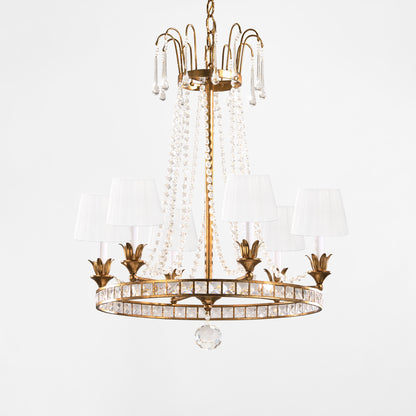 Antique gold Italian chandelier with crystals and white pleated shades.