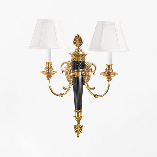 Luxurious brass sconce with black details.