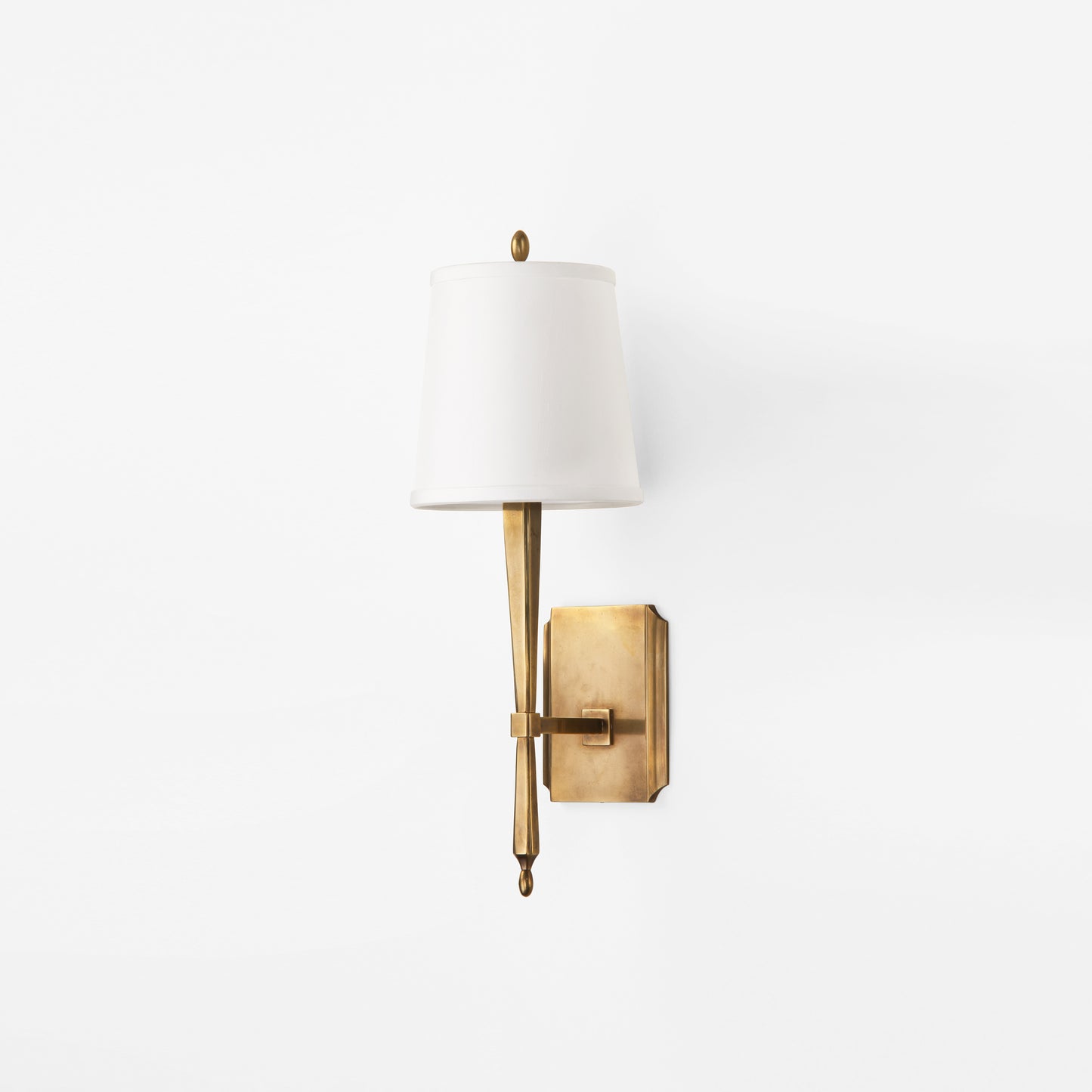 Luxury brass sconce with white shade.