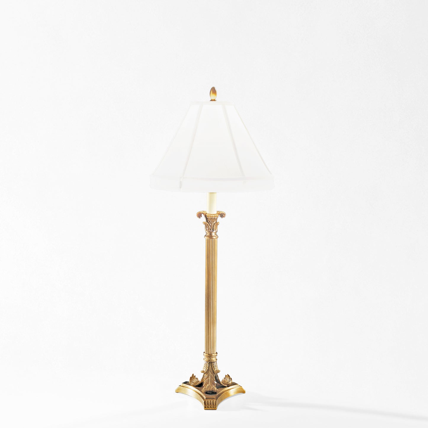Antique brass table lamp with white lamp shade.