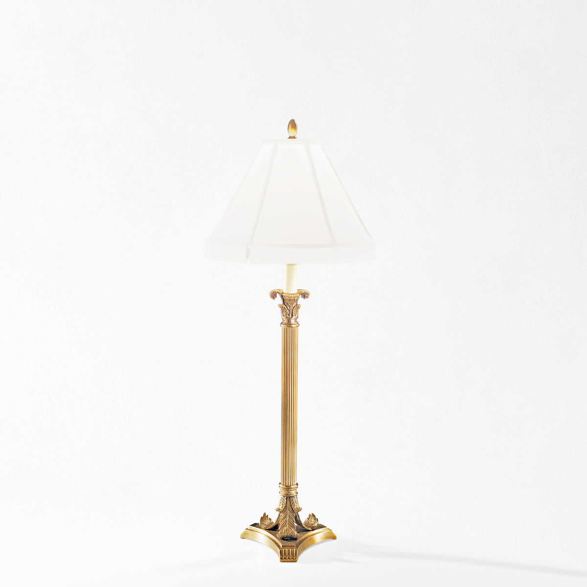 Antique brass table lamp with white lamp shade.
