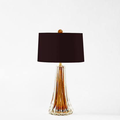 Amber Murano glass table lamp with black lamp shade.