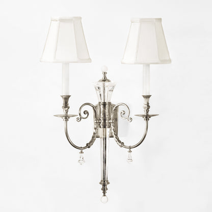 Crystal sconce with polished nickel trim and white shades.