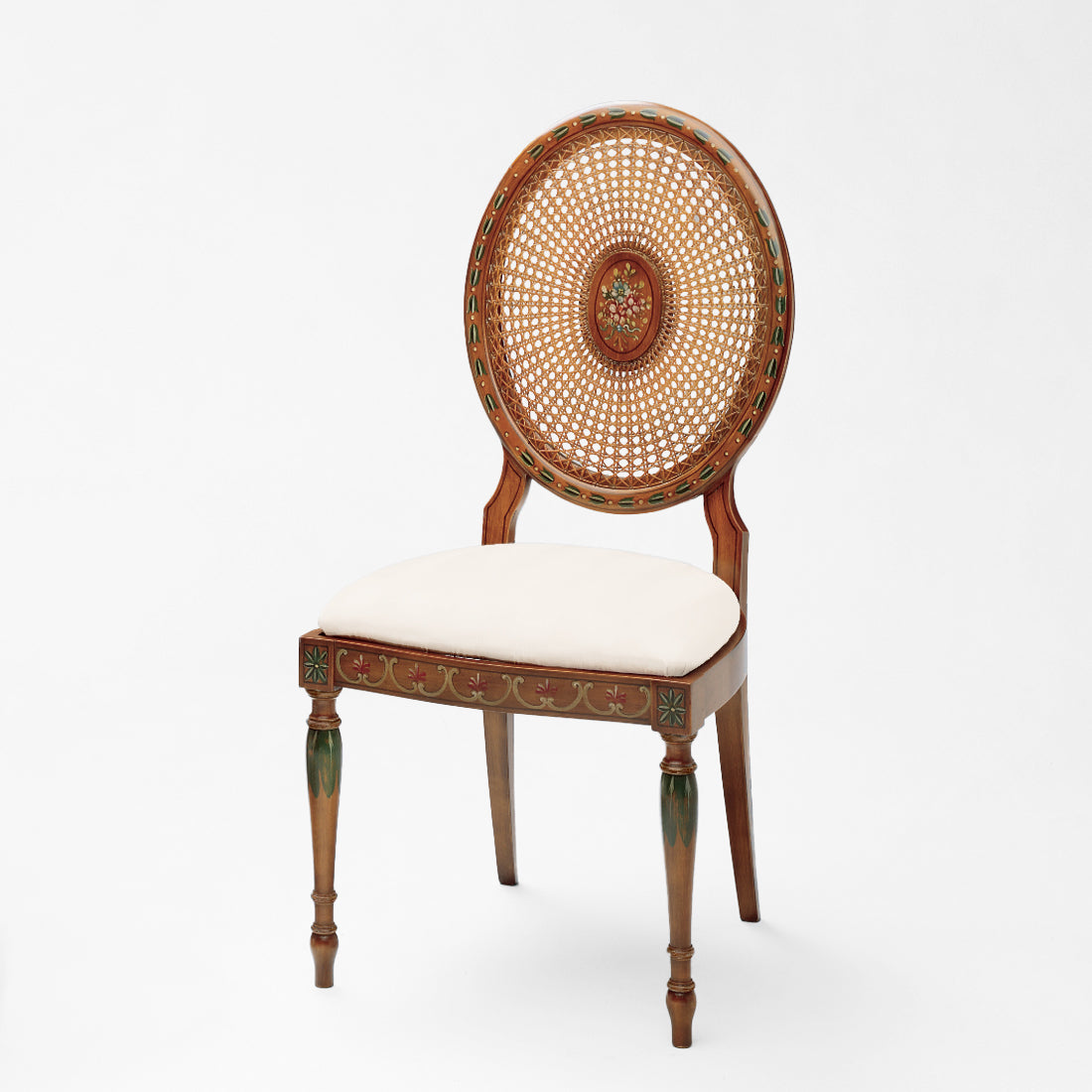 Italian cane chair with painted details and white fabric.