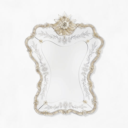 Antique Venetian glass mirror with ornate details.
