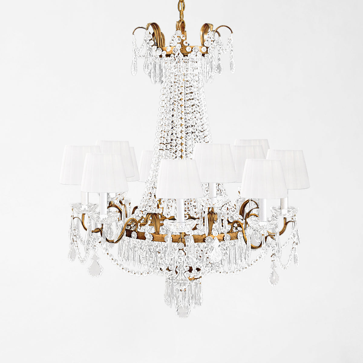 Luxurious antique gold Italian chandelier with white pleated shades.