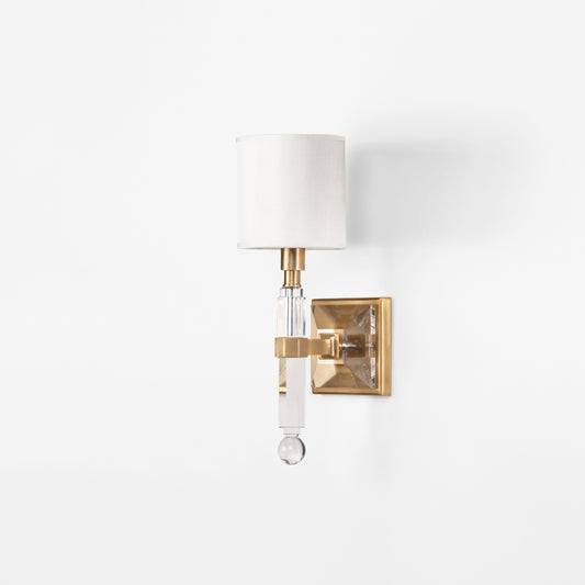 A crystal and antique brass sconce.