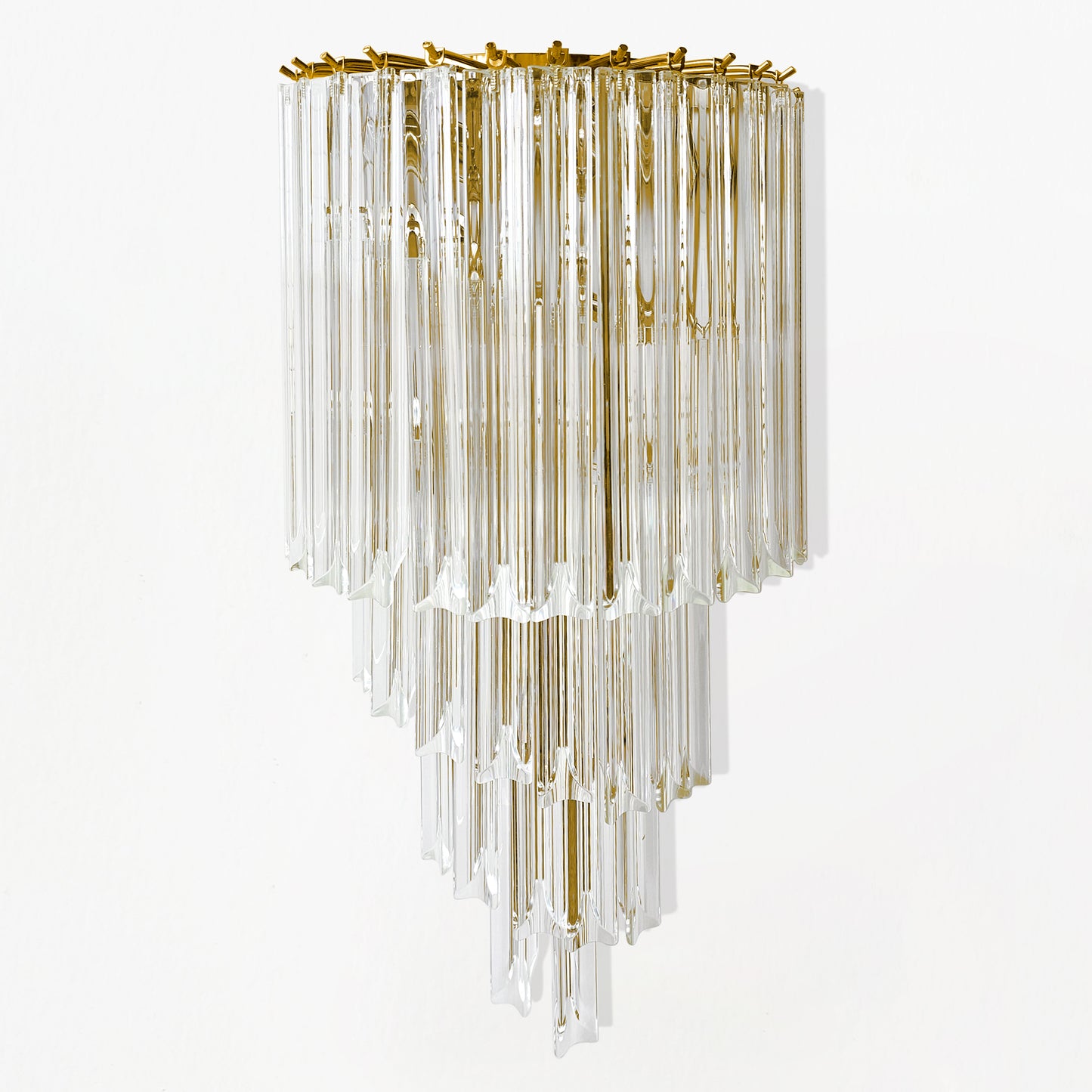 A glass sconce with gold hardware.