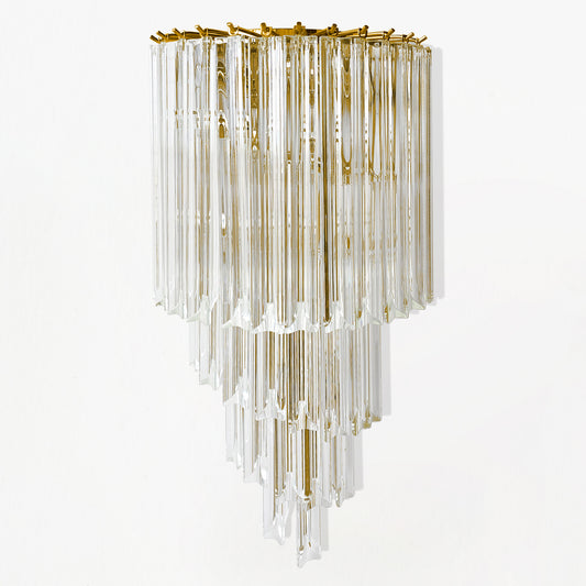 A glass sconce with gold hardware.