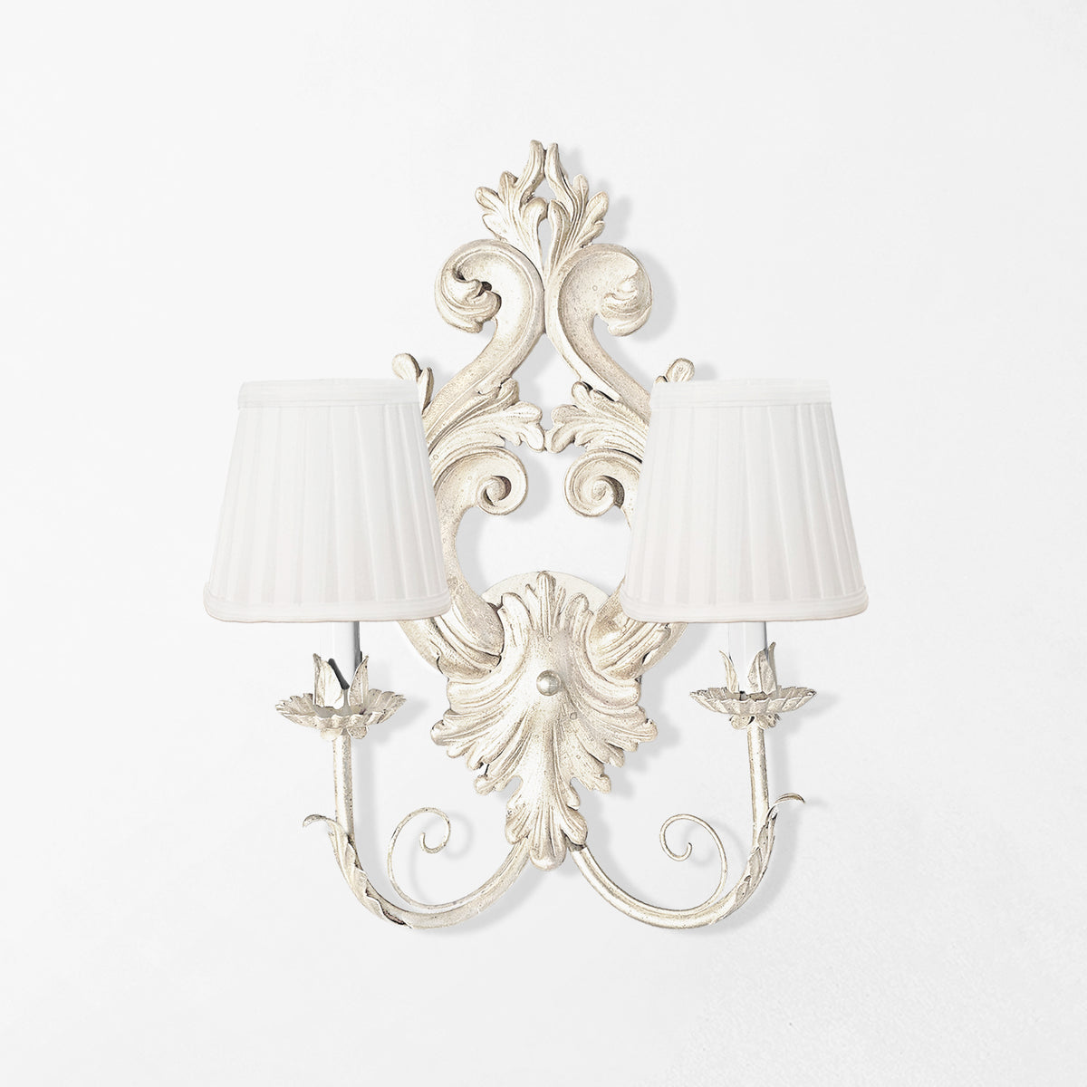 Traditional white luxury sconce with white pleated shades.