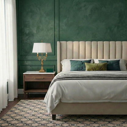 An antique brass table lamp with pleated shade in a luxurious bedroom with green walls.