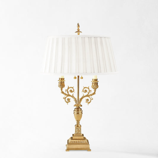 Antique brass table lamp with white pleated shade.