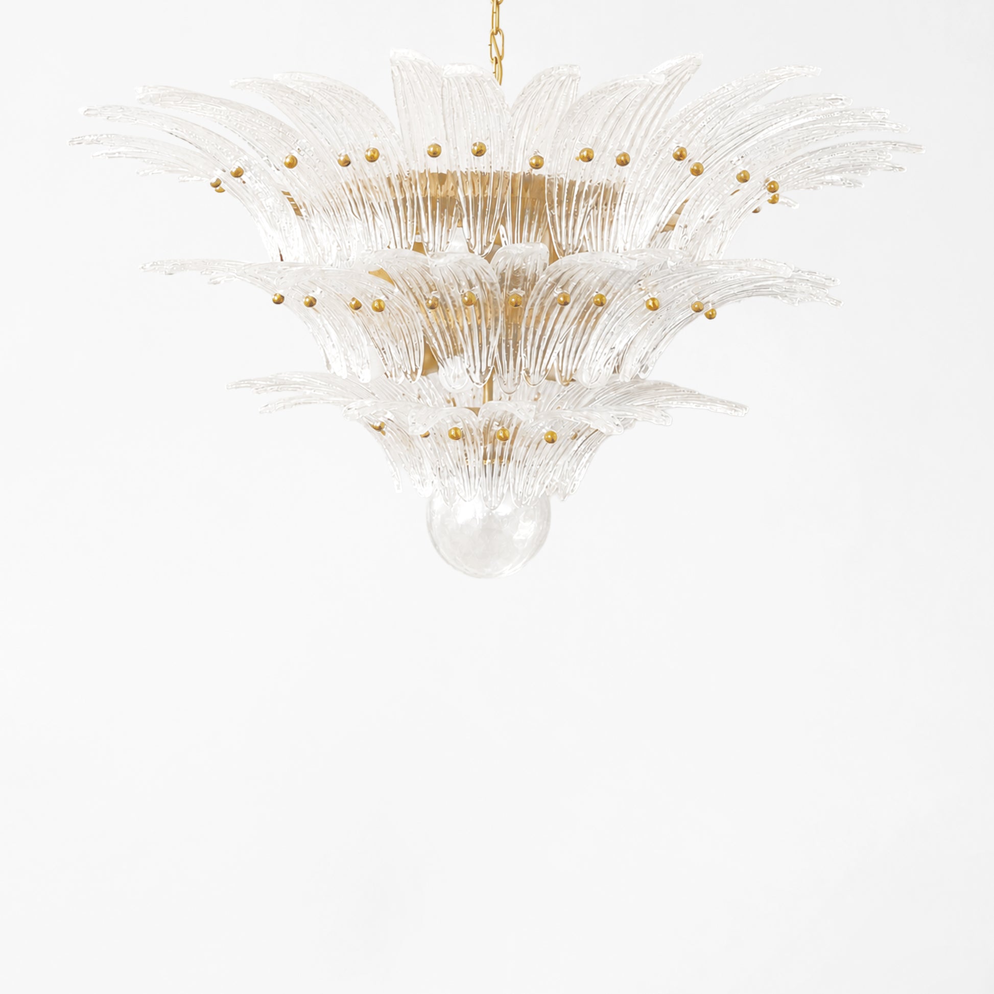 Clear Palm Murano glass chandelier with gold hardware.