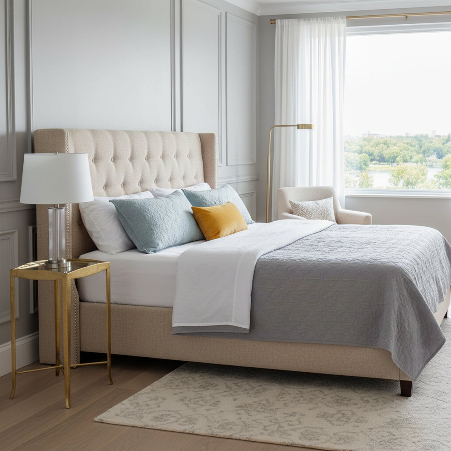 Transitional bedroom with a gold leaf end table.