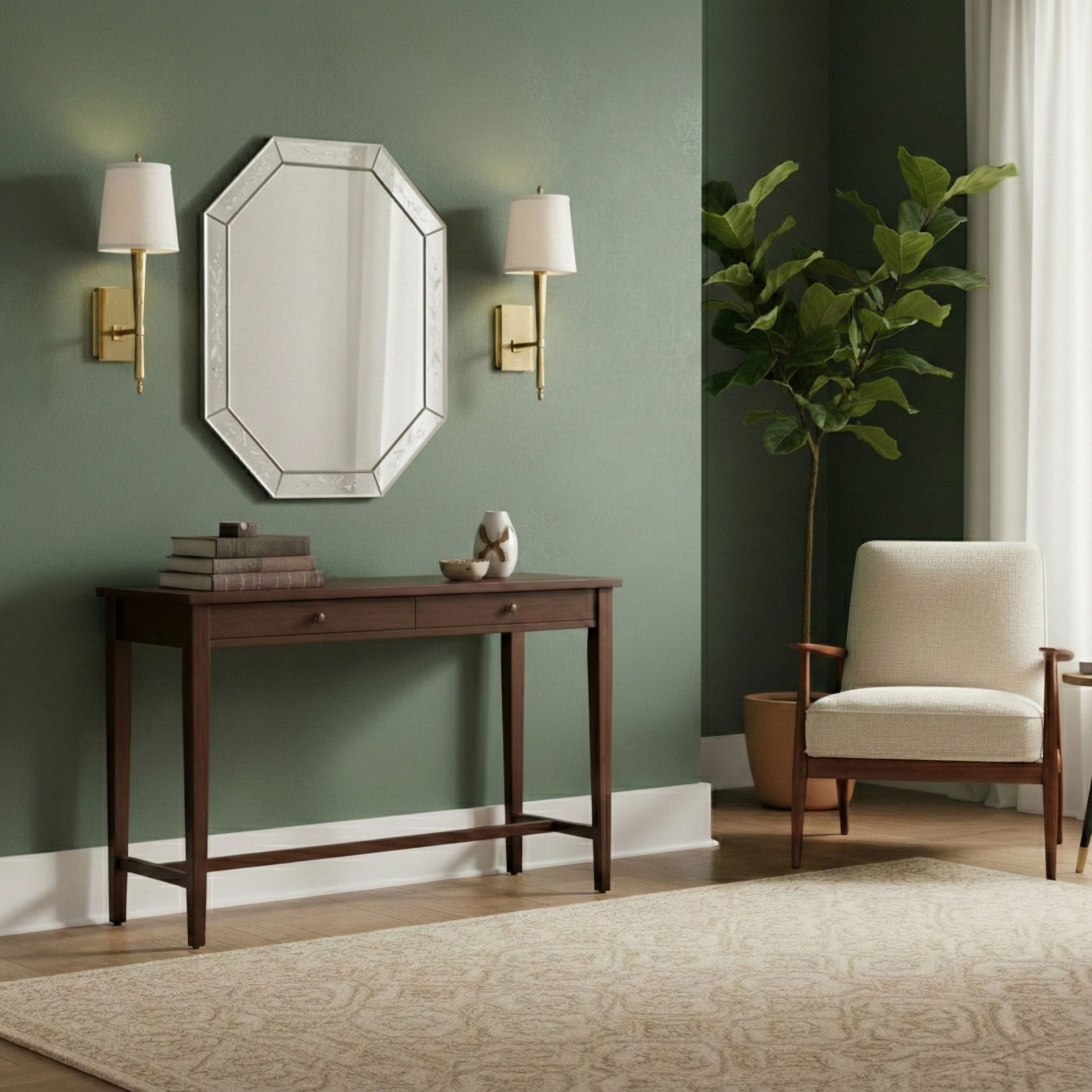 Decorative console table with a murano glass mirror and a pair of brass sconces against a green wall in a living room setting.