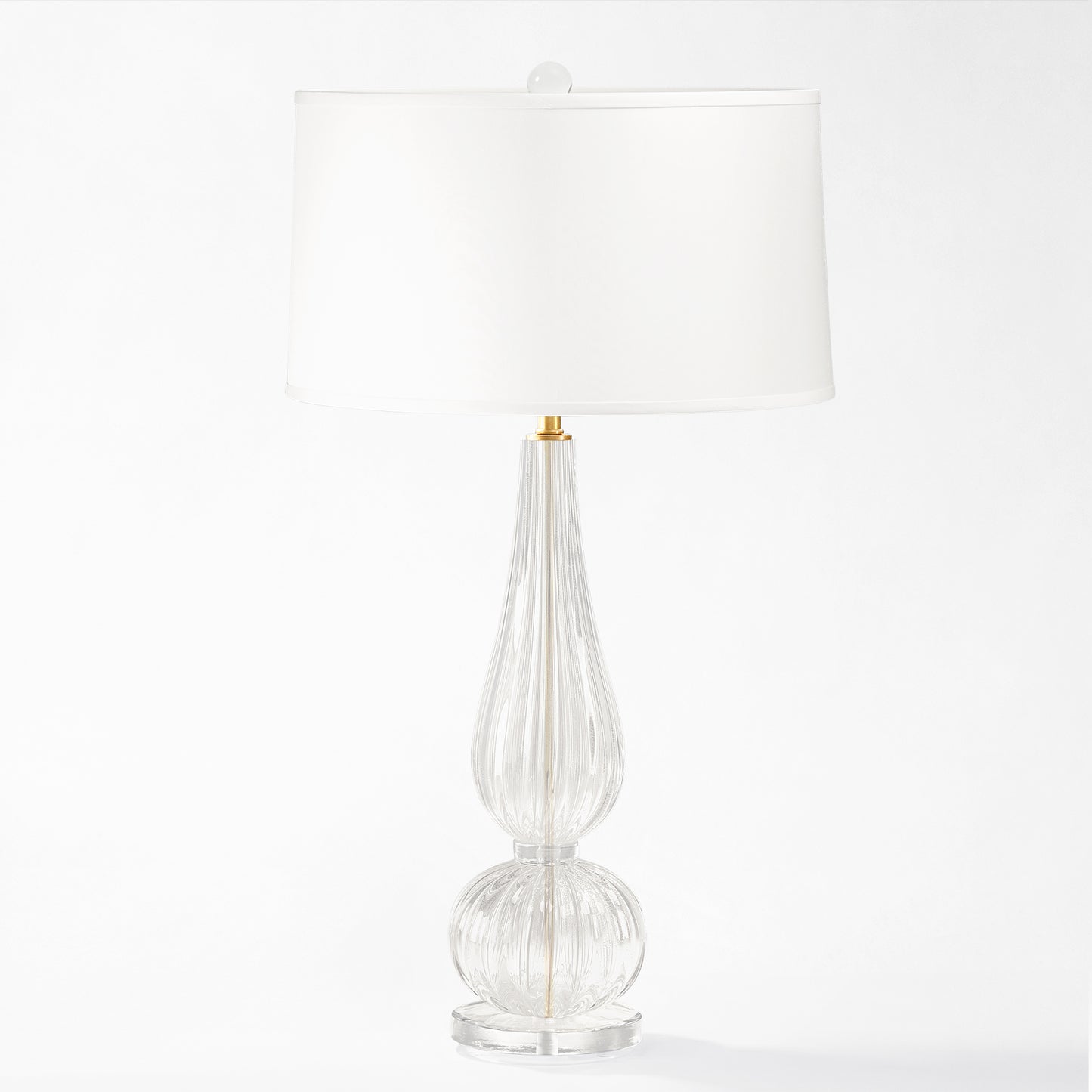 Clear Murano glass table lamp with white lamp shade.