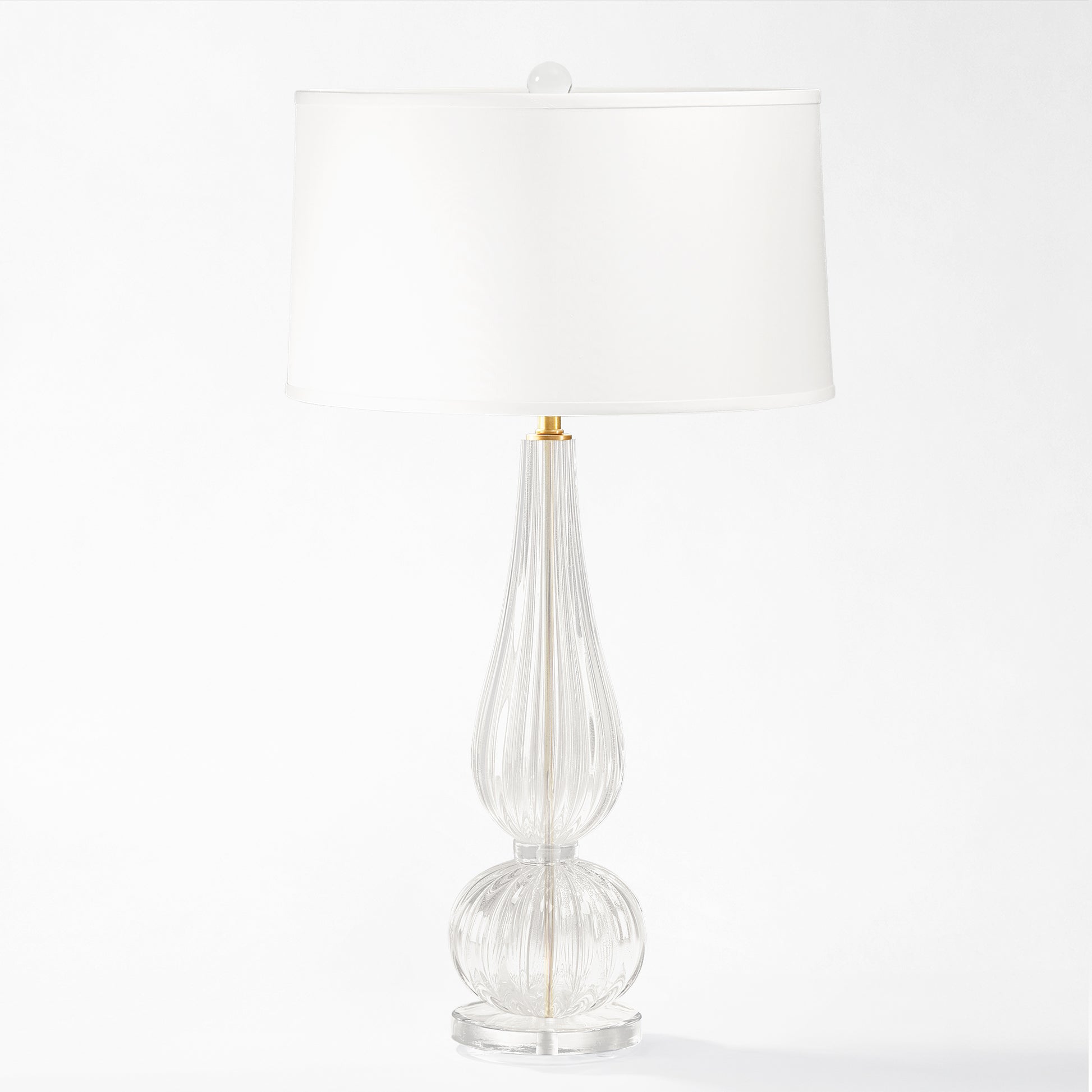 Clear Murano glass table lamp with white lamp shade.